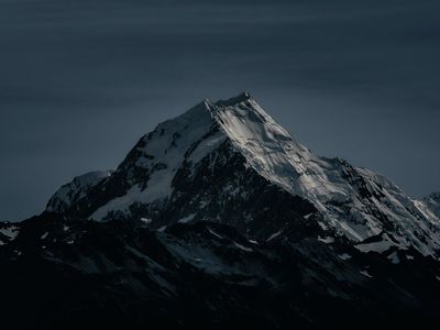 Mountain peak silhouettes against a clear night sky